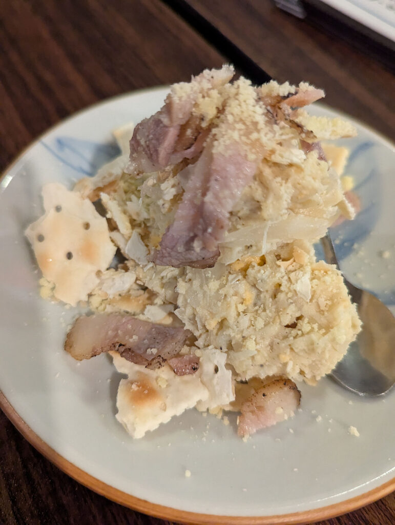 クラッカーとベーコンがトッピングされた大門屋の名物風ポテトサラダ
